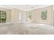 Spacious main bedroom with large windows, neutral carpeting and ensuite bathroom at 11933 Pasco Trails Blvd, Spring Hill, FL 34610