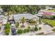 Aerial view of home featuring a manicured front yard, driveway, and fenced backyard at 6012 1St W Ave, Bradenton, FL 34209