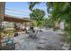 Expansive backyard showcasing a shaded patio, mature landscaping, and gravel-covered areas at 6012 1St W Ave, Bradenton, FL 34209