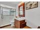 Updated bathroom with a glass shower, stylish vanity, and decorative mirror at 6012 1St W Ave, Bradenton, FL 34209
