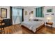 Serene bedroom with warm wood floors, soft lighting, and comfortable furnishings at 6012 1St W Ave, Bradenton, FL 34209