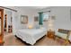 Cozy bedroom featuring a comfortable bed, natural light, and minimalist decor at 6012 1St W Ave, Bradenton, FL 34209