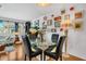 Open-concept dining area with a round glass table, black chairs, and decorative wall art at 6012 1St W Ave, Bradenton, FL 34209