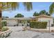 Well-maintained single-story house with stone landscaping and a vibrant front garden at 6012 1St W Ave, Bradenton, FL 34209