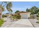 Charming single-story home with manicured landscaping, a driveway, and a welcoming entrance at 6012 1St W Ave, Bradenton, FL 34209