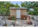 Exterior view of backyard storage shed with a pathway and landscaping at 6012 1St W Ave, Bradenton, FL 34209