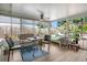Bright sunroom with a table and chairs, with views of the backyard through large windows at 6012 1St W Ave, Bradenton, FL 34209