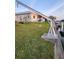 Spacious backyard with well-maintained grass and a waterfront with a metal davit at 3510 Magnolia Way, Punta Gorda, FL 33950