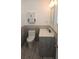 Bathroom with modern vanity, decorative wall cabinet, and gray wood-look tile at 3510 Magnolia Way, Punta Gorda, FL 33950
