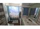 Cozy bathroom featuring rustic wall paneling, marble countertop, and a beach-themed shower curtain at 3510 Magnolia Way, Punta Gorda, FL 33950
