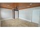 Bedroom features a wood plank ceiling, tile floors, and double-door closet at 3510 Magnolia Way, Punta Gorda, FL 33950