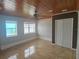 Bright bedroom features tile floors, ceiling fan, and double-door closet at 3510 Magnolia Way, Punta Gorda, FL 33950