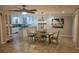 Open-concept dining room with kitchen view, tile flooring, and modern chandelier at 3510 Magnolia Way, Punta Gorda, FL 33950