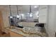 Kitchen featuring granite countertops, modern pendants, stainless appliances, and white cabinets at 3510 Magnolia Way, Punta Gorda, FL 33950