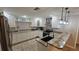 Open kitchen features granite countertops, white cabinets, and stainless steel appliances at 3510 Magnolia Way, Punta Gorda, FL 33950