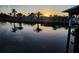 Waterfront sunset view reflecting palm trees and houses in the calm water at 3510 Magnolia Way, Punta Gorda, FL 33950