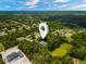 Aerial view of home with pin drop, surrounded by trees and lush landscaping at 6049 Patricia Pl, Weeki Wachee, FL 34607
