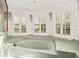 Large corner bathtub with jets and three windows with shutter-style blinds at 6049 Patricia Pl, Weeki Wachee, FL 34607