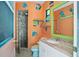 Whimsical bathroom featuring colorful fish decor, tiled walk-in shower, and unique mirror at 6049 Patricia Pl, Weeki Wachee, FL 34607