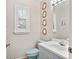 Charming bathroom with unique nautical-themed decor, including porthole mirrors and patterned wallpaper at 6049 Patricia Pl, Weeki Wachee, FL 34607