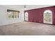 Spacious bedroom with neutral carpet and arched windows with shutters at 6049 Patricia Pl, Weeki Wachee, FL 34607