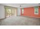 Spacious bedroom with neutral carpet, ceiling fan, and sliding glass doors to outdoor space at 6049 Patricia Pl, Weeki Wachee, FL 34607