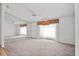 A spacious bedroom with neutral carpet, mirrored wall, and ceiling fan at 6049 Patricia Pl, Weeki Wachee, FL 34607
