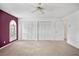Spacious bedroom features a ceiling fan, plush carpet, and large windows for natural light at 6049 Patricia Pl, Weeki Wachee, FL 34607