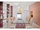 A formal dining room features tile flooring and a glass table with seating for ten at 6049 Patricia Pl, Weeki Wachee, FL 34607