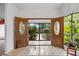 An elegant foyer with tiled floors and decorative wood double doors at 6049 Patricia Pl, Weeki Wachee, FL 34607