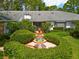 Beautifully landscaped front yard with a decorative fountain, enhancing curb appeal at 6049 Patricia Pl, Weeki Wachee, FL 34607