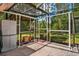 Screened greenhouse area with shelving and storage, perfect for gardening enthusiasts at 6049 Patricia Pl, Weeki Wachee, FL 34607