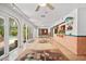 Bright hallway with tile floors, patterned rugs, and a built-in bar area for entertaining at 6049 Patricia Pl, Weeki Wachee, FL 34607