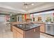 Open kitchen with an island, sleek countertops, and stainless steel appliances at 6049 Patricia Pl, Weeki Wachee, FL 34607