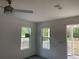 Bright living room with two windows and ceiling fan at 11876 Keylime Dr, New Port Richey, FL 34654