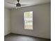 Spacious bedroom with ceiling fan and window coverings at 11876 Keylime Dr, New Port Richey, FL 34654