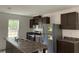 Modern kitchen with dark cabinets and spacious island at 11876 Keylime Dr, New Port Richey, FL 34654