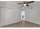 Bright bedroom featuring wood-look floors and spacious closet at 8150 Brent St # 734, Port Richey, FL 34668