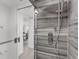 Walk-in shower with modern fixtures and wood-look tile at 8150 Brent St # 734, Port Richey, FL 34668