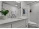 Modern bathroom with white vanity, quartz countertop, and a patterned shower at 8150 Brent St # 734, Port Richey, FL 34668