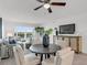 Modern dining area with a round table, four chairs, and a view of the living room at 8150 Brent St # 734, Port Richey, FL 34668
