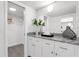Bathroom with granite countertop, white cabinets, and a large mirror at 8150 Brent St # 734, Port Richey, FL 34668