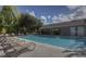 Relaxing community pool with lounge chairs and covered patio at 5318 Anhinga Trl, New Port Richey, FL 34653