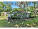 Rear view of the cottage showing additional outdoor space and AC unit at 1026 Roosevelt Ave, Spring Hill, FL 34604