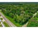 Aerial view of property highlighting its size and wooded lot at 1026 Roosevelt Ave, Spring Hill, FL 34604