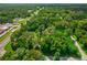 Aerial view showing the property's wooded surroundings and access roads at 1026 Roosevelt Ave, Spring Hill, FL 34604