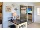 Bright office space showcasing coastal decor, a functional desk, and a view into an adjacent room at 4736 Jasper Dr # 207, New Port Richey, FL 34652