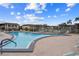 Community pool offers a refreshing escape with lounge chairs and well-maintained surroundings on a sunny day at 4736 Jasper Dr # 207, New Port Richey, FL 34652