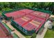 Aerial view of multiple well-maintained pickleball and tennis courts at 1383 Dartford Dr, Tarpon Springs, FL 34688