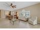 Living room features ample seating, a view into the dining room and kitchen at 1383 Dartford Dr, Tarpon Springs, FL 34688